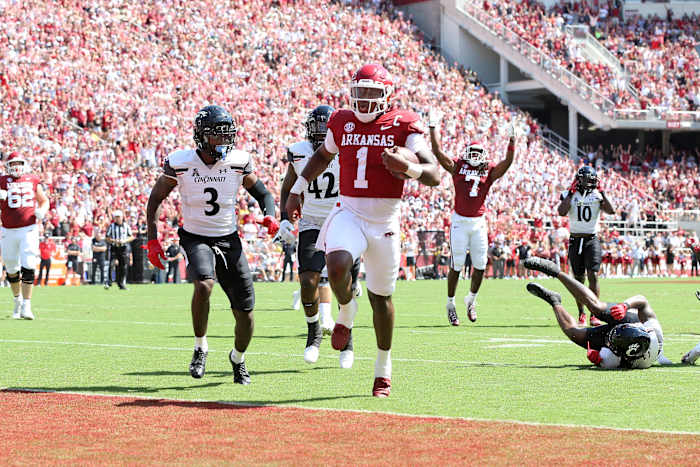 Sep 3, 2022; Fayetteville, Arkansas, USA; Arkansas Razorbacks quarterback KJ Jefferson (1) rushes for a touchdown in the first quarter as Cincinnati Bearcats safety Ja von Hicks (3) defends at Donald W. Reynolds Razorback Stadium. Mandatory Credit: Nelson Chenault-USA TODAY Sports
